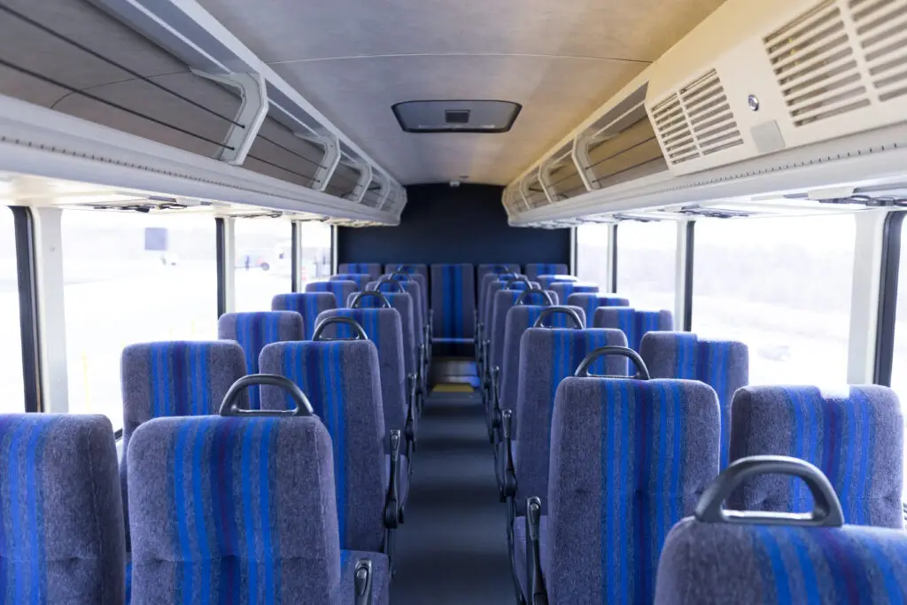 Xpress bus interior looking towards the back from the front. Clean chairs and floors.