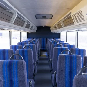 Xpress bus interior looking towards the back from the front. Clean chairs and floors.